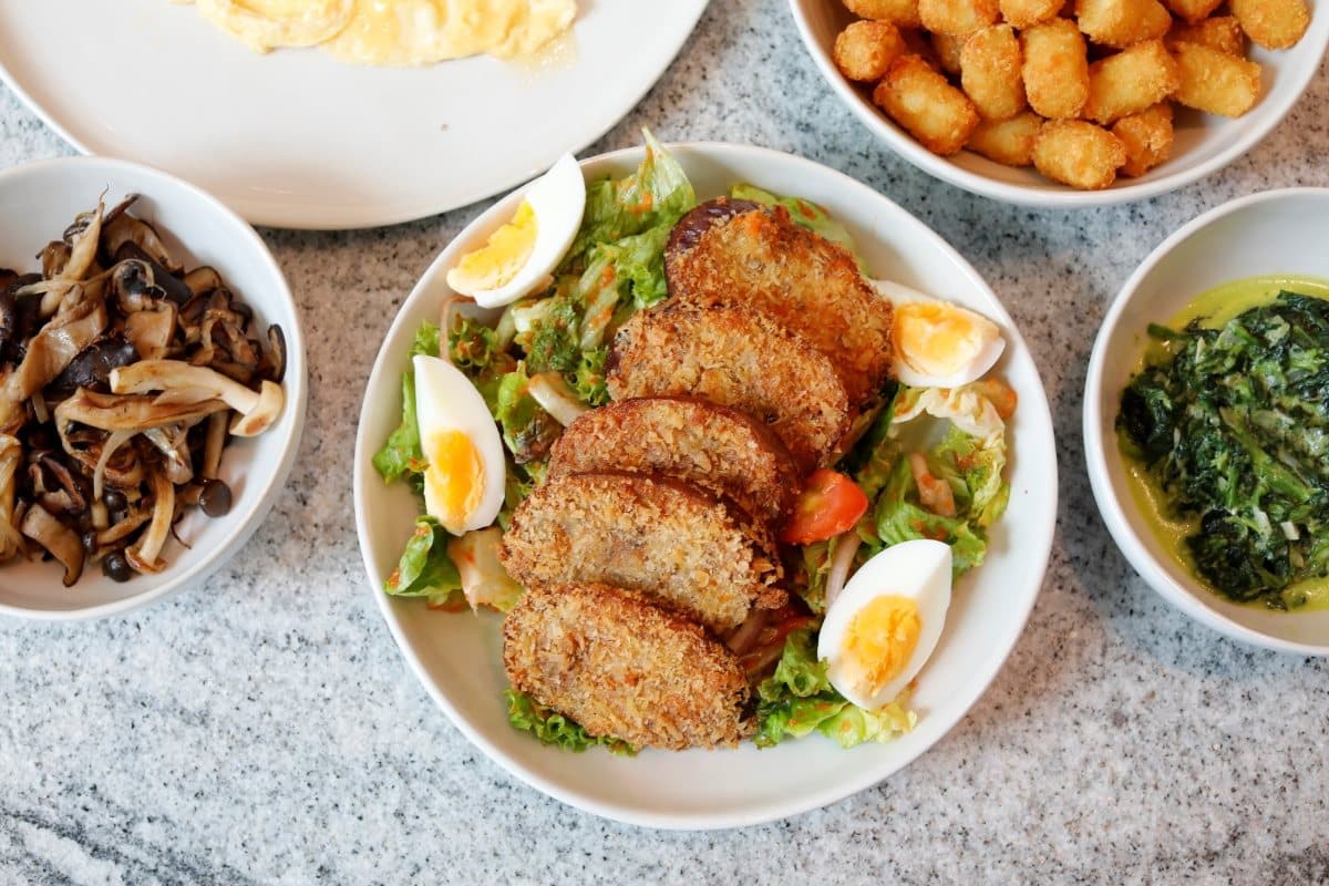 Lucine by LUNA’s Eggplant Salad with panko-crusted eggplant fritters, fresh lettuce, and baby spinach